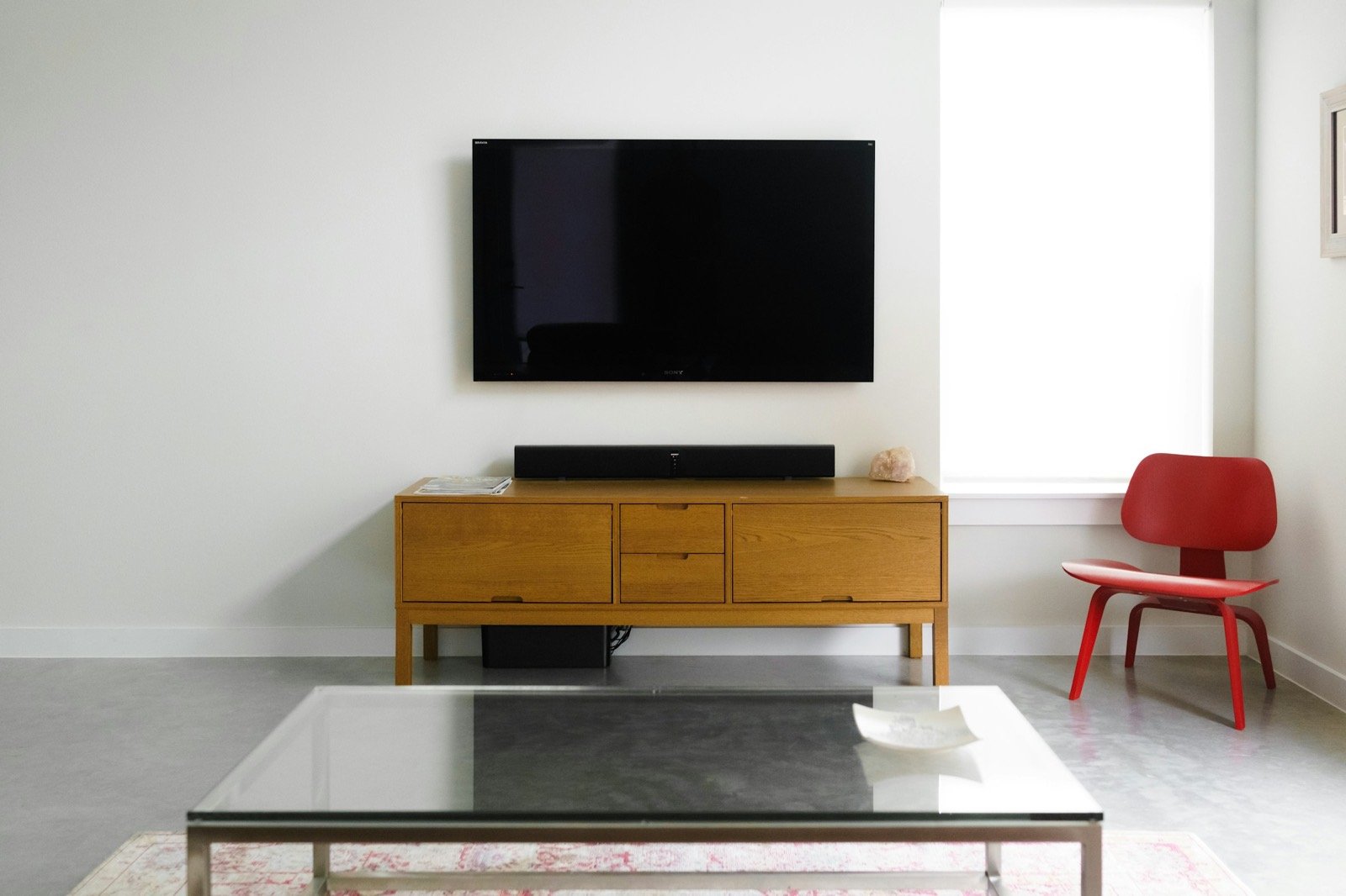 A wall-mounted TV showing a SmartCtrl pairing code
