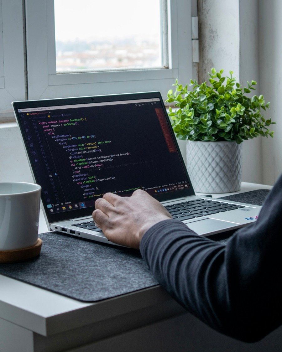 Developer writing code on a laptop