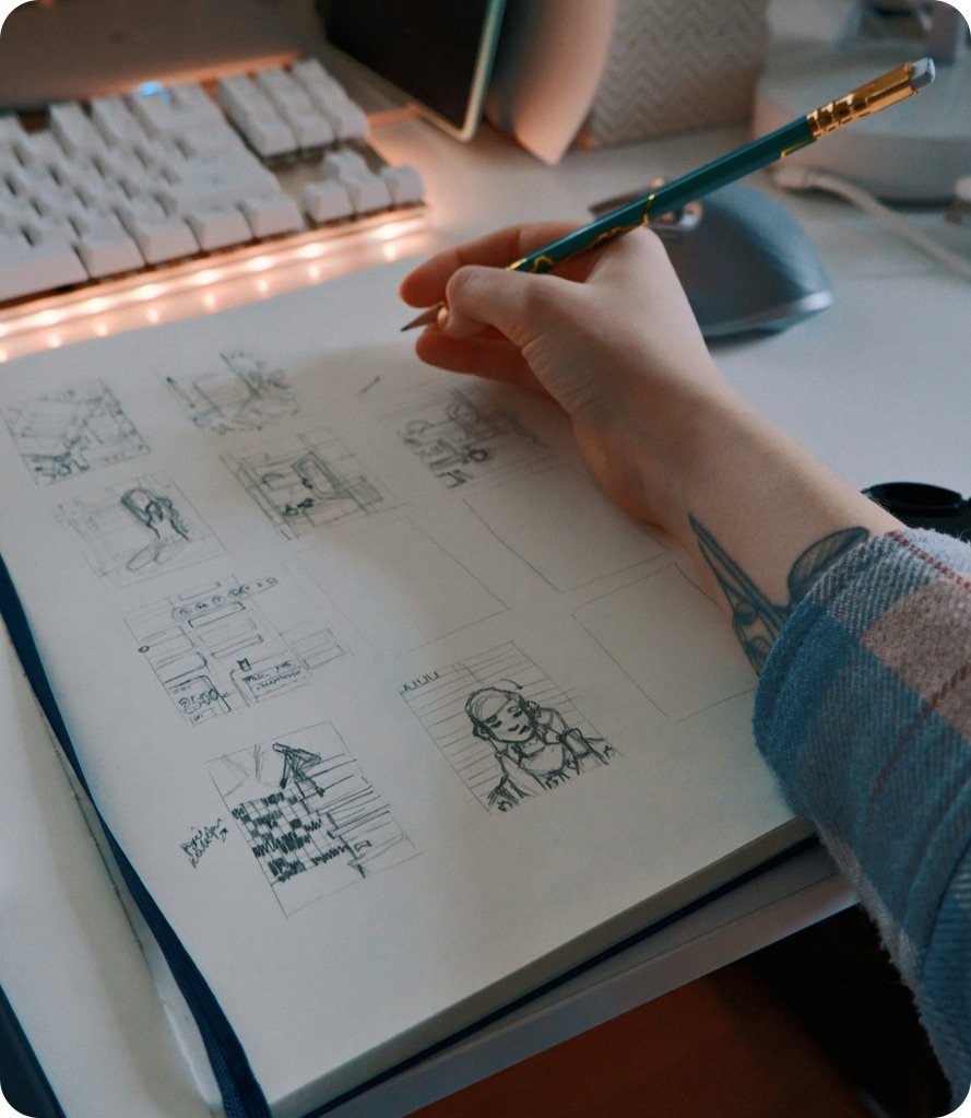Designer sketching app screens on paper