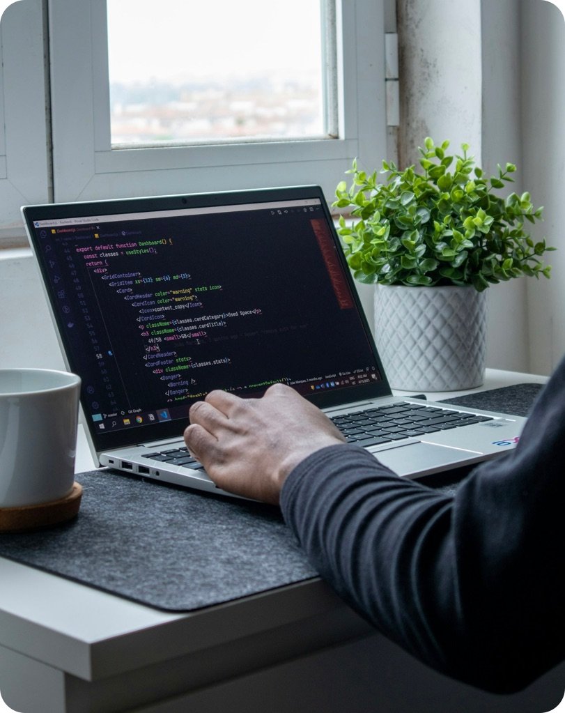 Developer writing code on a laptop
